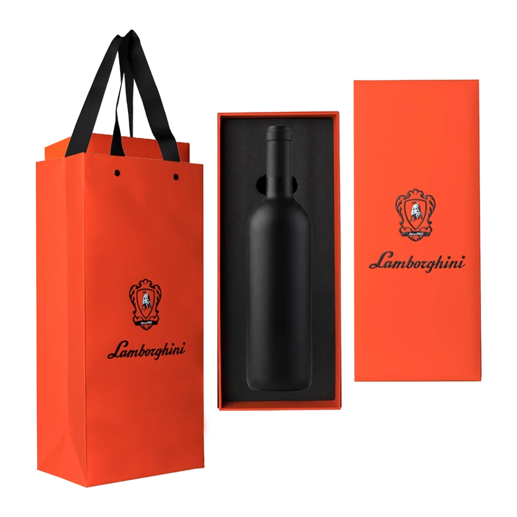 Pomarańczowa torba i pudełko prezentowe z logo Lamborghini, zawierające matową, czarną butelkę wina spokojnego