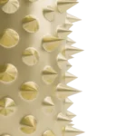 Side profile of the bottle showing sharp gold spikes protruding from the gold surface against a white background