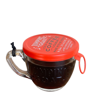 A miniature clear cup with a red lid containing a 50 ml shot of Jumping Goat coffee liqueur