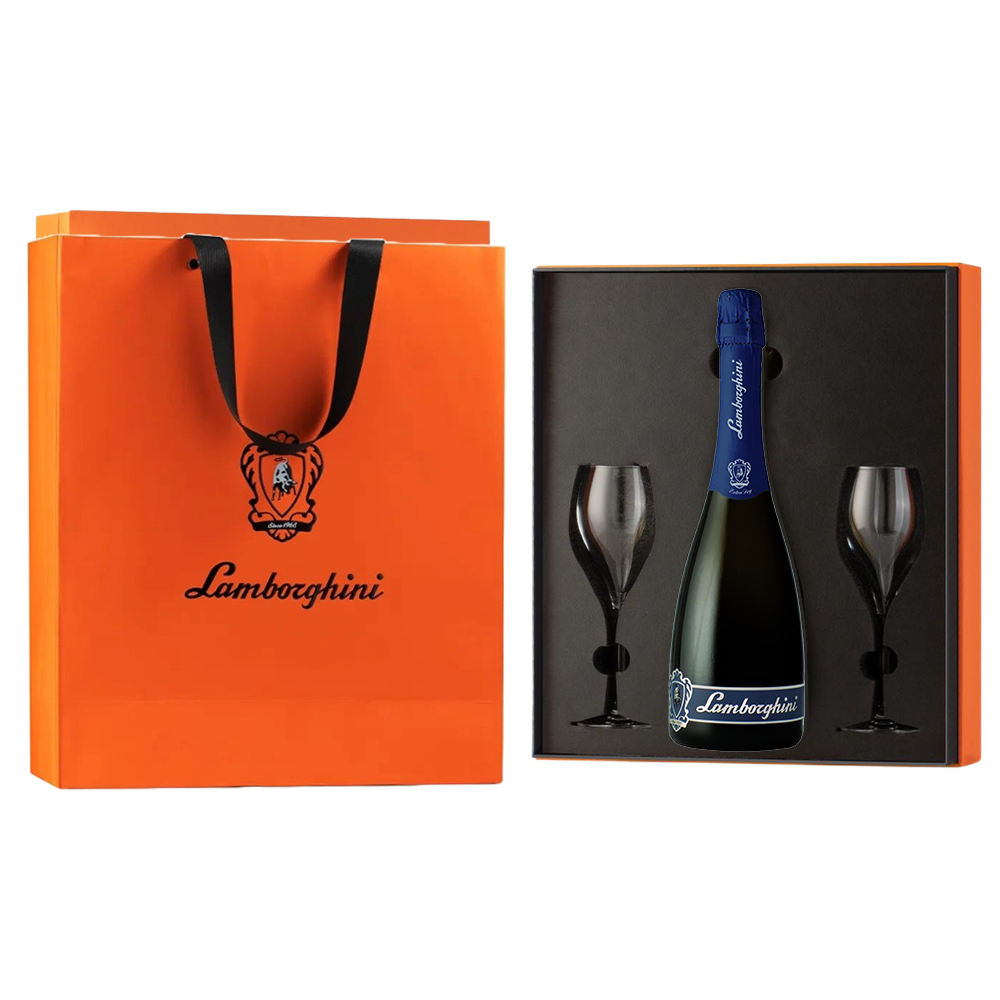 A dark bottle of Lamborghini Extra Dry Vino Spumante wine with a blue label and two glasses in a luxury orange gift box next to a Lamborghini gift bag on a black background.