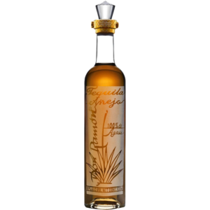 A slender bottle of Tequila Don Ramon Punta Diamante Anejo with amber liquor against a black background.