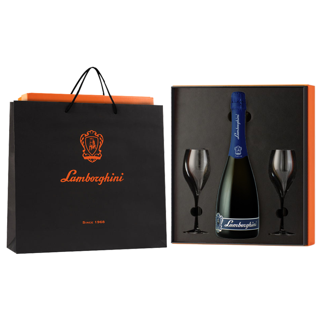 A dark bottle of Lamborghini Extra Dry Vino Spumante wine with a blue label and two glasses in a luxury orange gift box next to a Lamborghini gift bag on a black background.