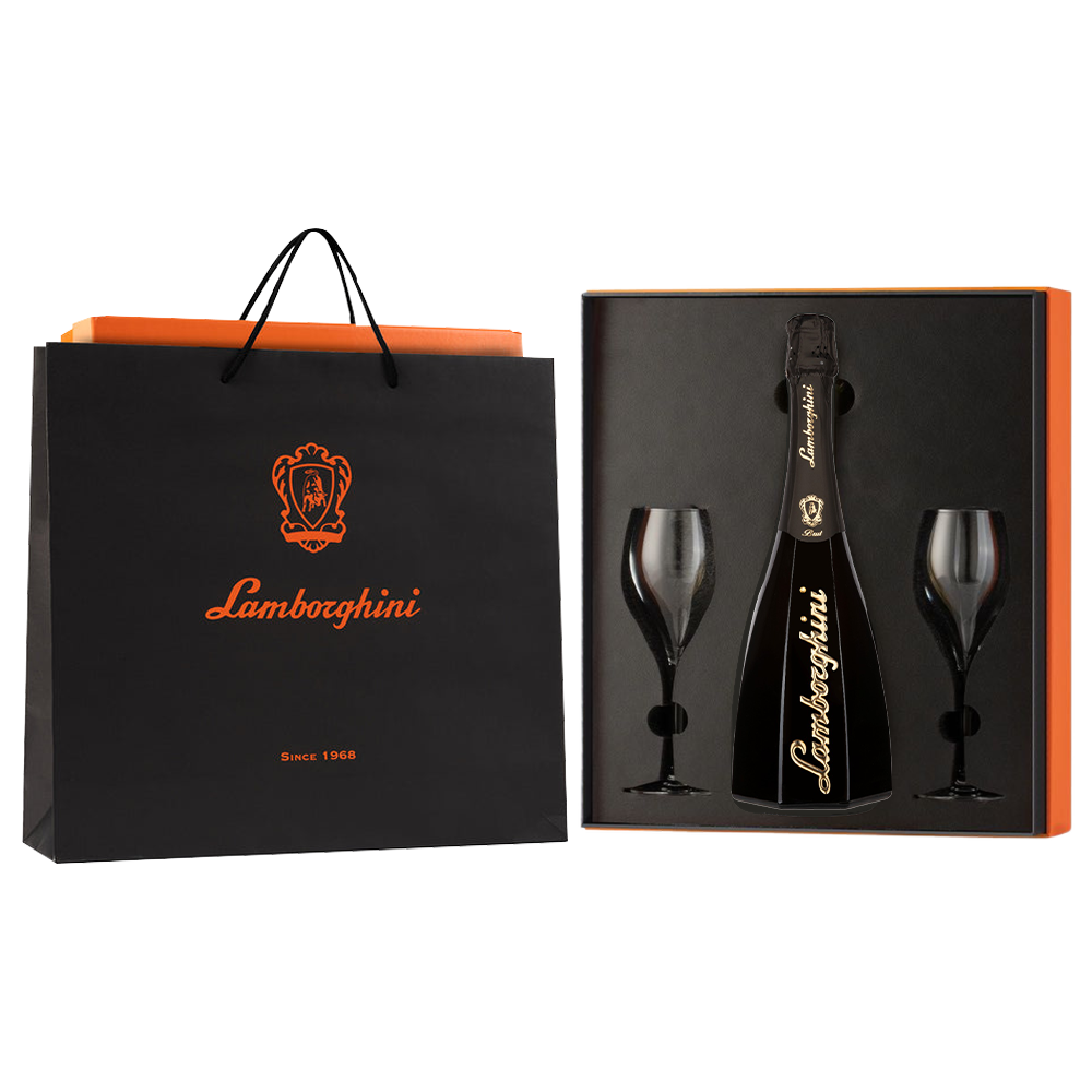 A black, octagonal bottle of Lamborghini Ottagonale Brut wine with gold details and two glasses packed in an orange gift box next to a branded gift bag on a black background.