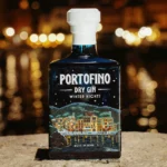 Portofino Dry Gin Winter Nights Limited Edition 500 ml – granatowa butelka na tle rozświetlonego nocą portu.